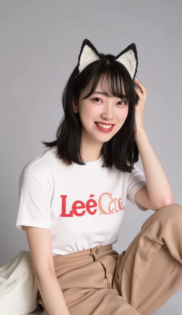 Headshot of a Japanese woman wearing a LEE logo t-shirt and cool Honda logo chinos and cat ears on her head
